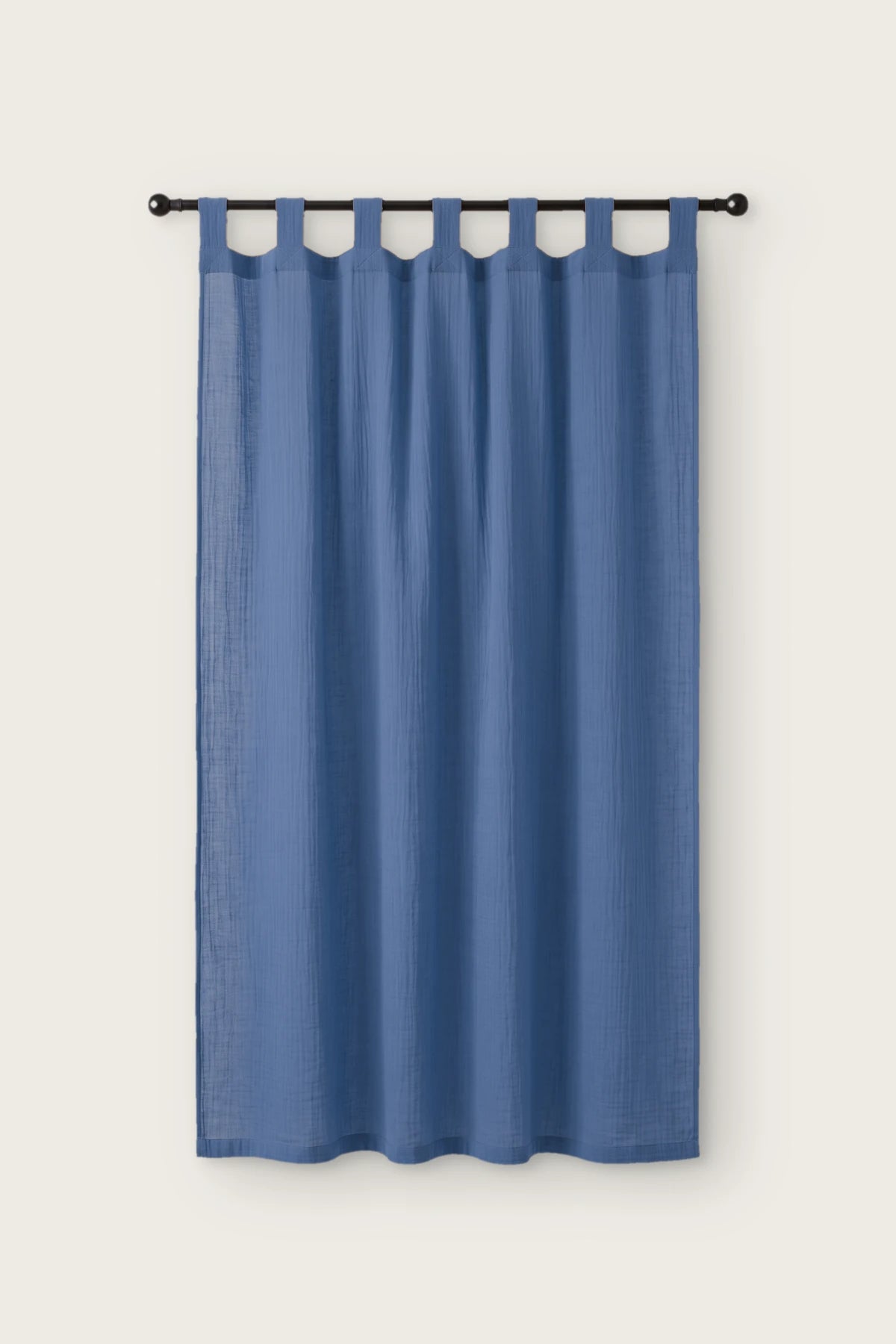 2-layer muslin cotton curtain panel in blue, single tab top panel on a black rod, front view