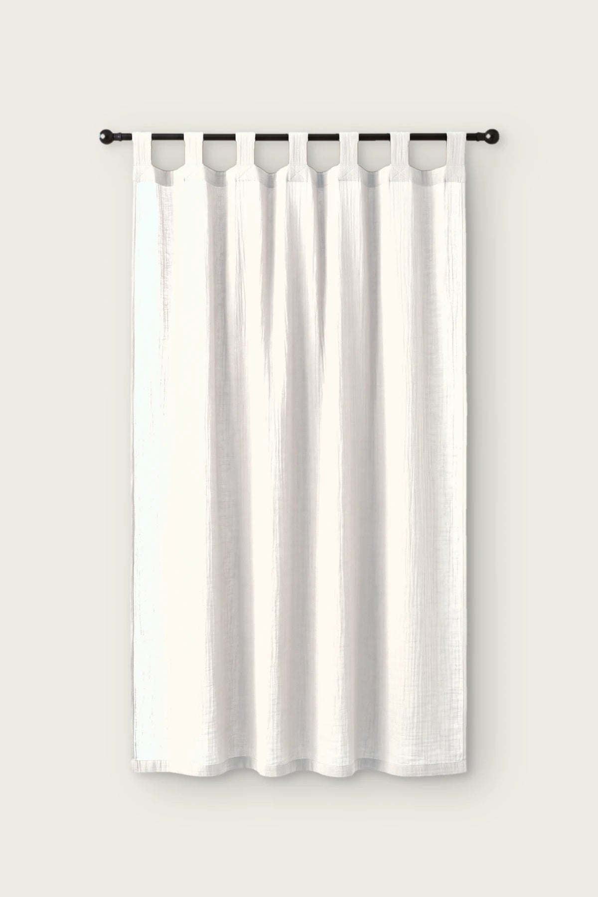 2-layer muslin cotton curtain panel in white, single tab top panel on a black rod, front view