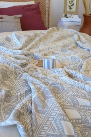 Anthracite patterned muslin bedspread showing woven Anatolian motifs by Vivamaison