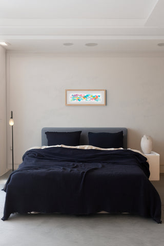 Black muslin bedspread draped on bed showing handwoven 4-layer weave by Vivamaison