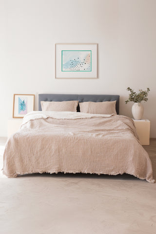 Brown muslin bedspread draped on bed showing handwoven 4-layer weave by Vivamaison