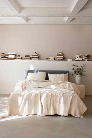 Natural muslin bedspread draped on bed showing handwoven 4-layer weave by Vivamaison
