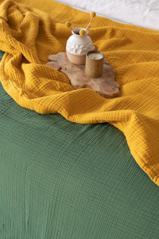 Mustard Sage Green reversible double-sided 8-layer muslin bedspread lifestyle close up. Handwoven Denizli, OEKO-TEX. Vivamais