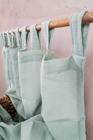 Angled close-up of mint tab top header. Handwoven 2-layer muslin cotton curtain, Denizli, OEKO-TEX. Vivamaison.
