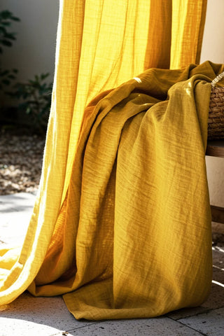 Mustard fabric draped over bench, texture closeup. Handwoven 2-layer muslin cotton curtain, Denizli, OEKO-TEX. Vivamaison.