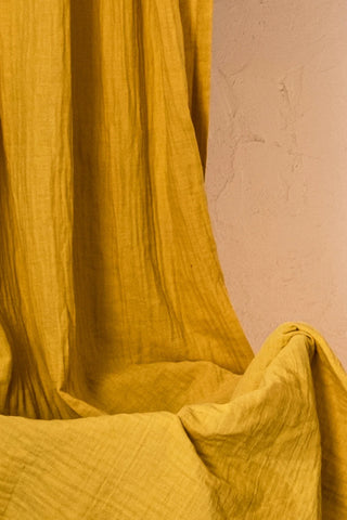 Crinkled mustard double gauze texture closeup. Handwoven 2-layer muslin cotton curtain, Denizli, OEKO-TEX. Vivamaison.