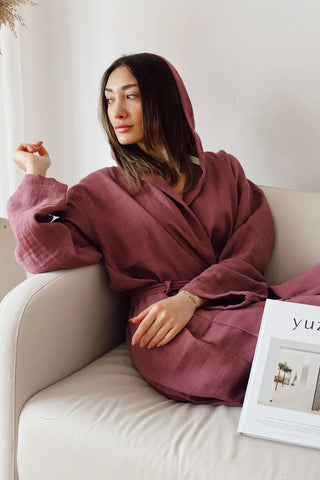 Burgundy 2-layer muslin hooded bathrobe hood up seated closeup. Handwoven Turkish cotton Denizli, OEKO-TEX. Vivamaison.