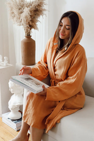 Light tile 2-layer muslin hooded bathrobe hood up seated. Handwoven Turkish cotton Denizli, OEKO-TEX. Vivamaison.