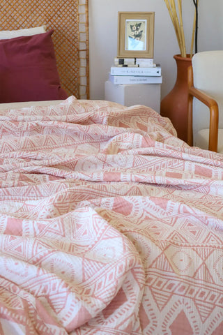 Ethnic Pink handwoven 3-layer patterned muslin Turkish cotton bedspread folded flat lay. Woven patterns, Denizli, OEKO-TEX. V