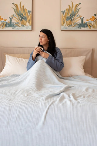 Baby Blue handwoven 4-layer muslin Turkish cotton bedspread folded flat lay. Long-staple Denizli, OEKO-TEX. Vivamaison.