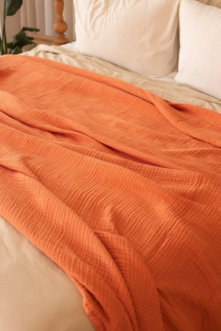 Tile handwoven 4-layer muslin Turkish cotton bedspread folded flat lay. Long-staple Denizli, OEKO-TEX. Vivamaison.