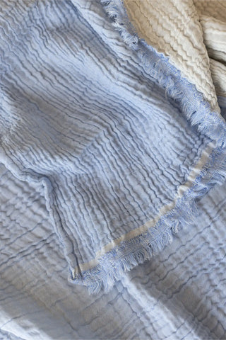 Baby Blue handwoven 4-layer soft muslin fringed bedspread lifestyle. Tasseled edges, Denizli, OEKO-TEX. Vivamaison.