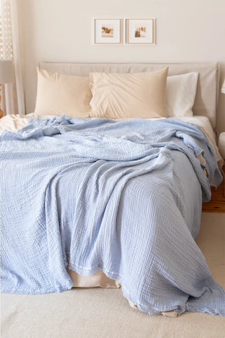 Baby Blue handwoven 4-layer soft muslin fringed bedspread styled bedroom. Tasseled edges, Denizli, OEKO-TEX. Vivamaison.