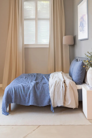 Indigo Blue handwoven 4-layer soft muslin fringed bedspread folded flat lay. Tasseled edges, Denizli, OEKO-TEX. Vivamaison.