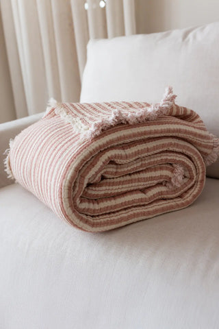 Terracotta Striped handwoven 8-layer muslin Turkish cotton quilt folded flat lay. Hand-tied fringe Denizli, OEKO-TEX. Vivamai