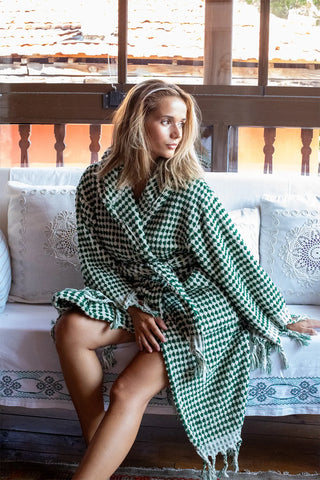 Green white chickpea bathrobe seated front lifestyle. Handwoven Turkish cotton Denizli, OEKO-TEX. Vivamaison.