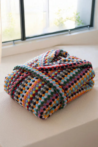 Rainbow chickpea bathrobe folded by window. Handwoven Turkish cotton Denizli, OEKO-TEX. Vivamaison.