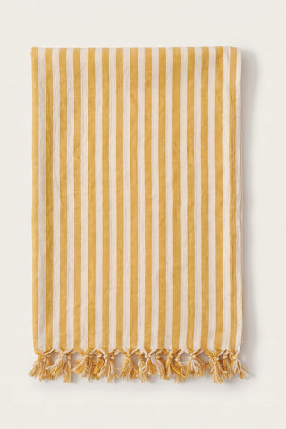 Classic striped Turkish cotton peshtemal towel in yellow, folded front view with knotted fringe