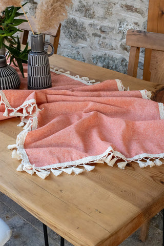 Orange handwoven Turkish cotton tassel table runner overhead. Hand-tied tassels Denizli, OEKO-TEX. Vivamaison.