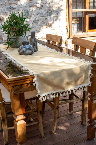 Yellow handwoven Turkish cotton tassel table runner folded flat lay. Hand-tied tassels Denizli, OEKO-TEX. Vivamaison.