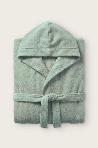 Handwoven Turkish cotton terry hooded bathrobe in sage green, folded front view with hood and tied belt