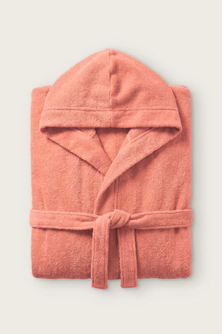 Handwoven Turkish cotton terry hooded bathrobe in terracotta, folded front view with hood and tied belt