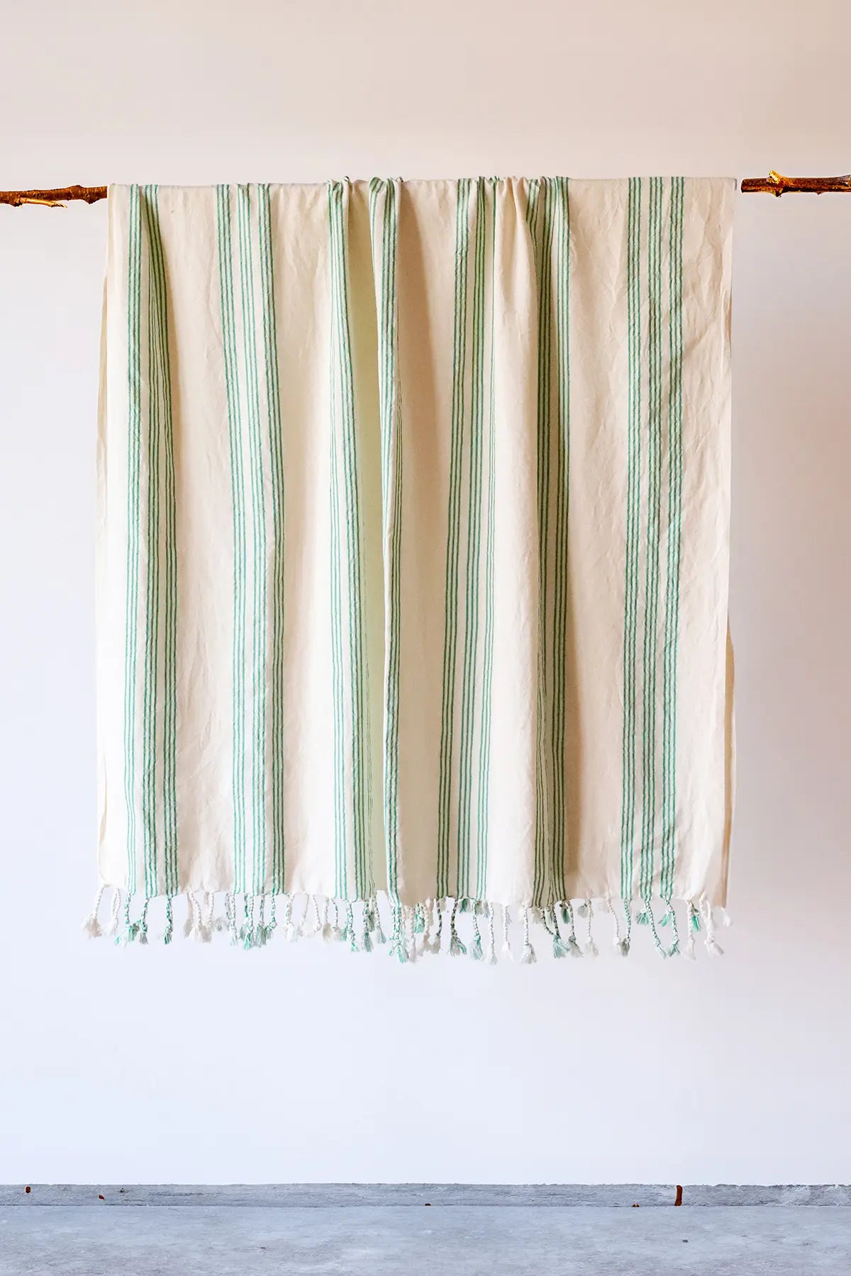 Green elegant striped peshtemal towel hanging full view. Handwoven Turkish cotton Denizli, OEKO-TEX. Vivamaison.