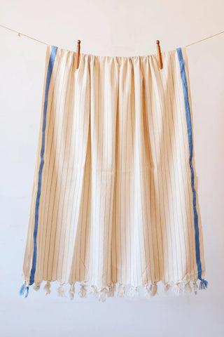 Blue luxury striped peshtemal towel hanging full view. Handwoven Turkish cotton Denizli, OEKO-TEX. Vivamaison.