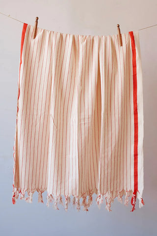 Red luxury striped peshtemal towel hanging full view. Handwoven Turkish cotton Denizli, OEKO-TEX. Vivamaison.