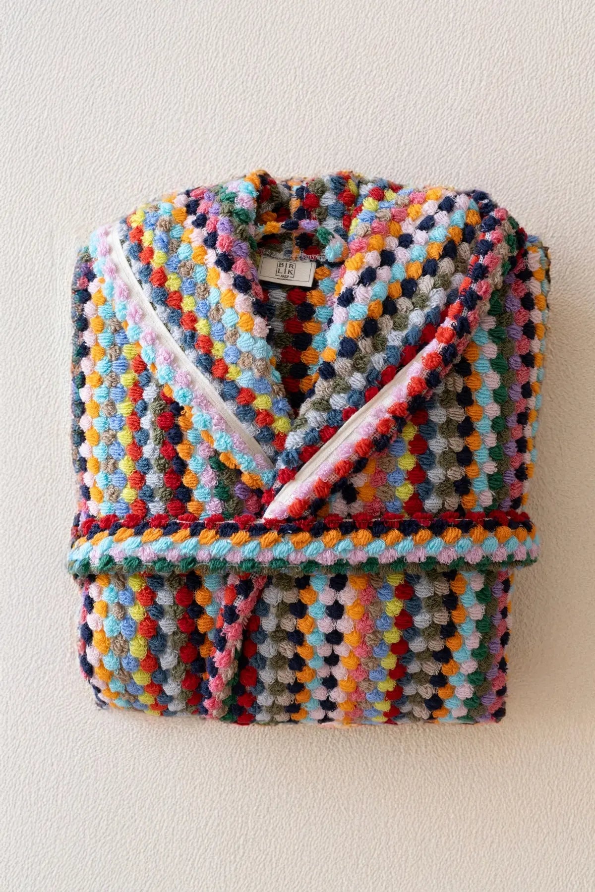 Rainbow mosaic bathrobe folded hanging display. Handwoven Turkish cotton Denizli, OEKO-TEX. Vivamaison.