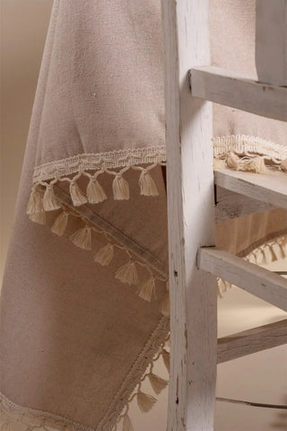 Beige handwoven solid color Turkish cotton tassel tablecloth overhead. Tasseled edges Denizli, OEKO-TEX. Vivamaison.