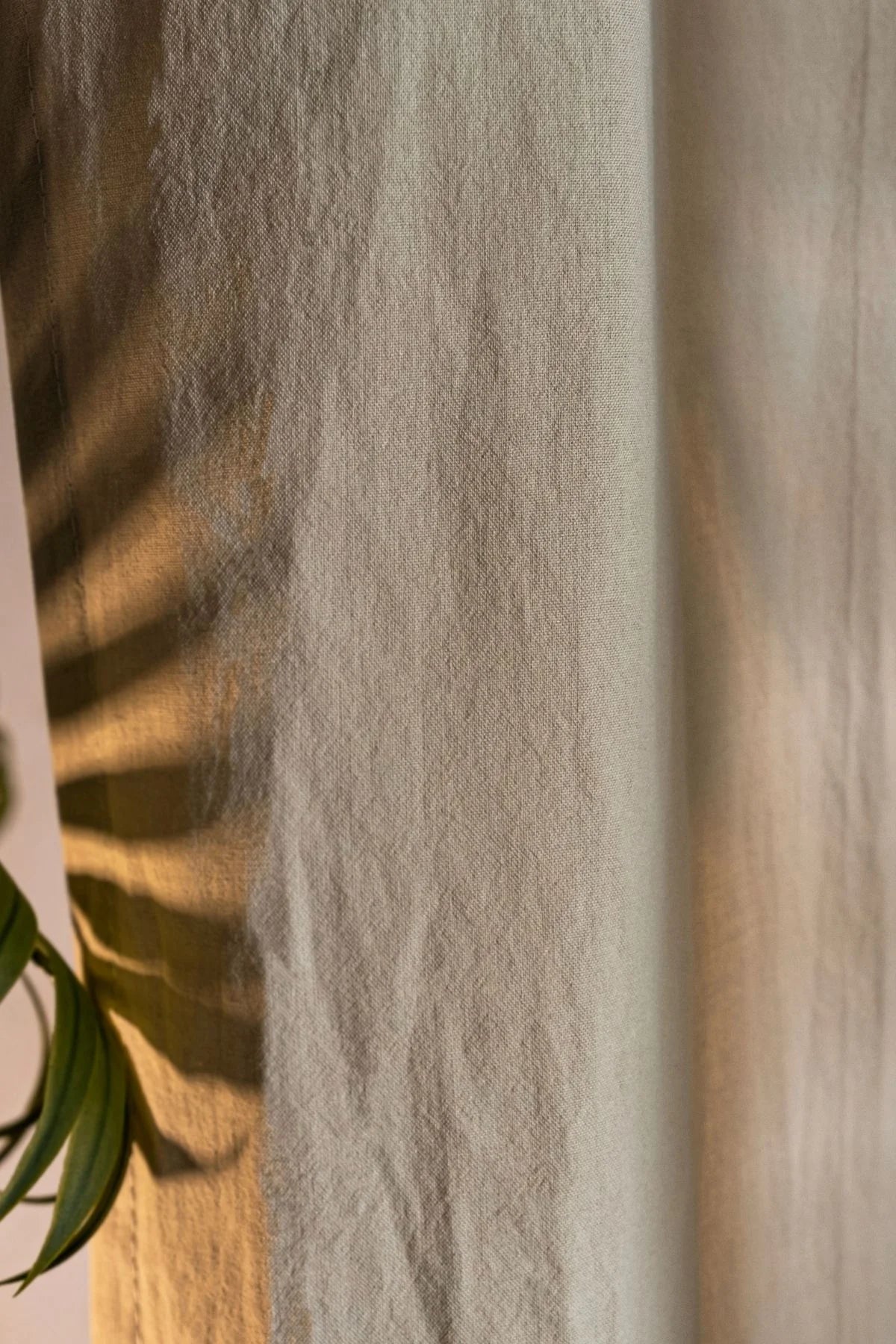 Beige stonewashed cotton curtain fabric texture close-up. Handwoven in Denizli, OEKO-TEX. Vivamaison.