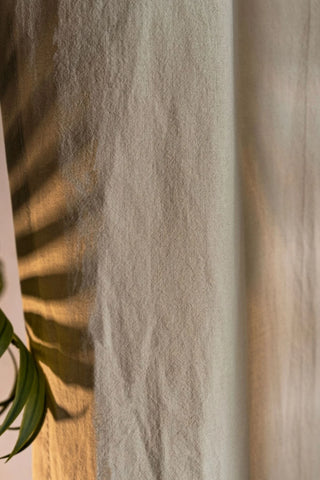 Beige stonewashed cotton curtain fabric texture close-up. Handwoven in Denizli, OEKO-TEX. Vivamaison.
