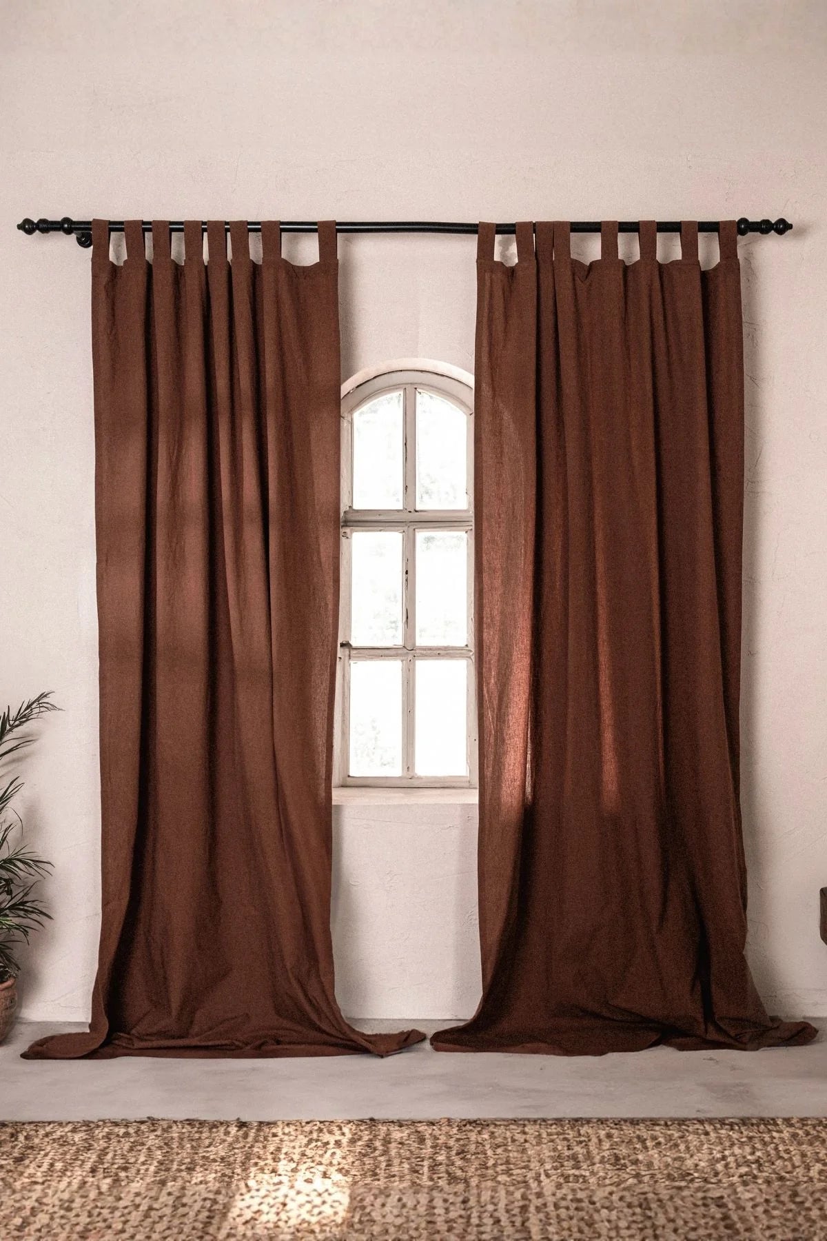 Brown stonewashed cotton curtain panels framing an arched window. Handwoven in Denizli, OEKO-TEX. Vivamaison.