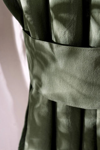 Stitching detail of the dark green stonewashed cotton curtain tieback band. Handwoven in Denizli, OEKO-TEX. Vivamaison.