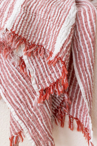 Red striped peshtemal towel fringe detail closeup. Handwoven Turkish cotton Denizli, OEKO-TEX. Vivamaison.
