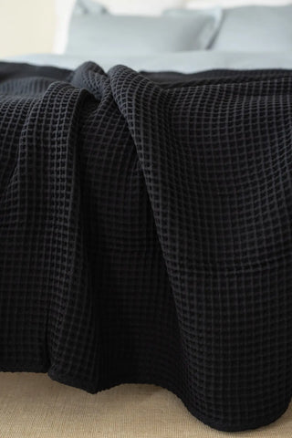 Black handwoven Turkish cotton waffle weave bedspread folded flat lay. 350 GSM Denizli, OEKO-TEX. Vivamaison.