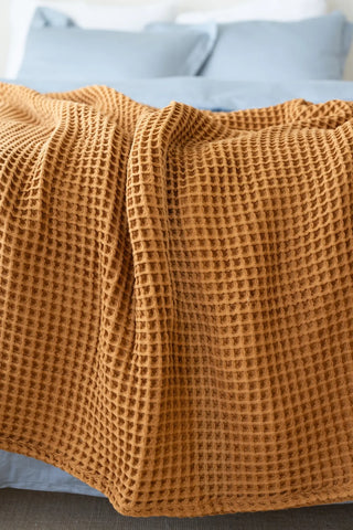 Caramel handwoven Turkish cotton waffle weave bedspread folded flat lay. 350 GSM Denizli, OEKO-TEX. Vivamaison.