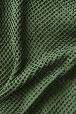 Dark Green handwoven Turkish cotton waffle weave bedspread folded flat lay. 350 GSM Denizli, OEKO-TEX. Vivamaison.