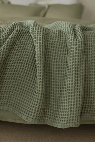 Sage Green handwoven Turkish cotton waffle weave bedspread folded flat lay. 350 GSM Denizli, OEKO-TEX. Vivamaison.