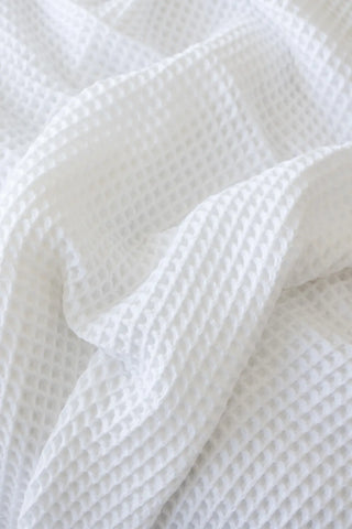 White handwoven Turkish cotton waffle weave bedspread folded flat lay. 350 GSM Denizli, OEKO-TEX. Vivamaison.