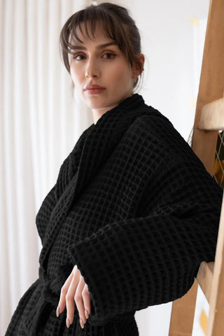 Black waffle hooded bathrobe side closeup, waffle weave detail. Handwoven Turkish cotton Denizli, OEKO-TEX. Vivamaison.