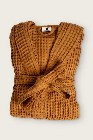 Handwoven waffle hooded bathrobe in caramel, folded front view with tied belt