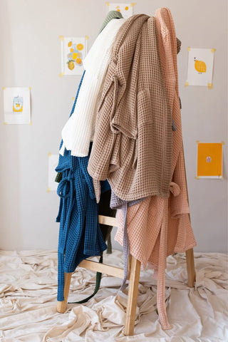 Handwoven waffle hooded bathrobes in 12 colors on display. Turkish cotton from Denizli, OEKO-TEX. Vivamaison.