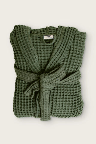 Handwoven waffle hooded bathrobe in dark green, folded front view with tied belt