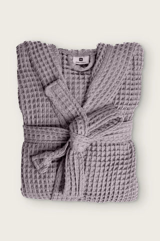 Handwoven waffle hooded bathrobe in grey, folded front view with tied belt