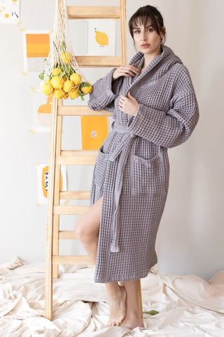 Grey waffle hooded bathrobe full side view, spa lifestyle. Handwoven Turkish cotton Denizli, OEKO-TEX. Vivamaison.