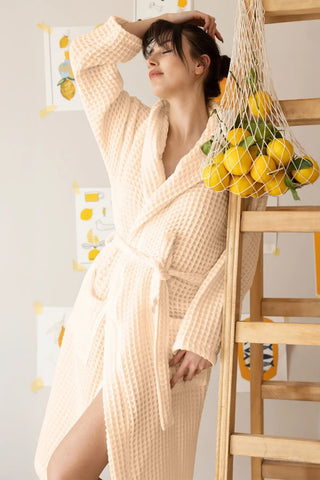 Natural waffle hooded bathrobe side view, spa lifestyle. Handwoven Turkish cotton Denizli, OEKO-TEX. Vivamaison.