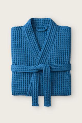 Handwoven waffle kimono bathrobe in indigo blue, folded front view with tied belt