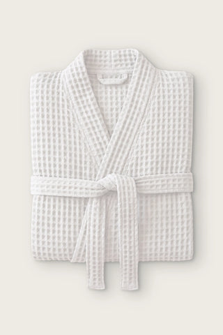Handwoven waffle kimono bathrobe in natural, folded front view with tied belt